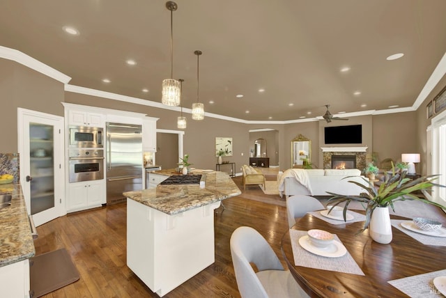 3287 Congressional Ct, Fairfield, CA 94534 - kitchen featuring built in appliances, a center island, a ceiling fan, white cabinets, and recessed lighting
