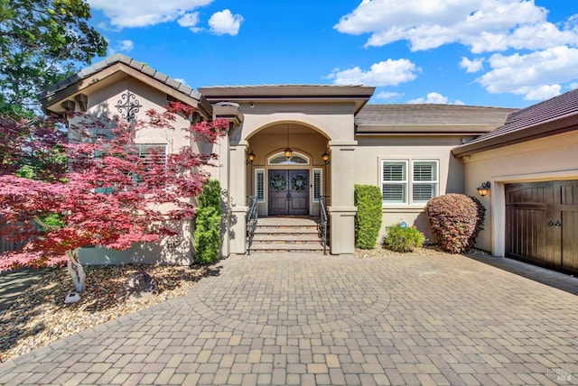 3287 Congressional Ct, Fairfield, CA 94534 - property entrance with stucco siding, french doors, decorative driveway, a garage, and a tile roof