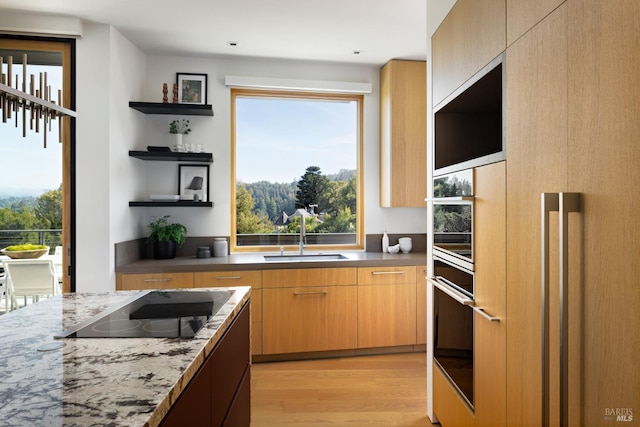 2 Upper Alcatraz Pl, Mill Valley, CA 94941 - kitchen with open shelves, a sink, black electric stovetop, light wood finished floors, and oven