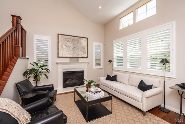 4152 Casper Way, Napa, CA 94558 - living room with high vaulted ceiling, wood finished floors, stairway, a glass covered fireplace, and baseboards