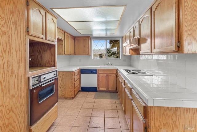 241 Camellia St, Fairfield, CA 94533 - kitchen with white appliances, under cabinet range hood, tasteful backsplash, a sink, and light tile patterned flooring