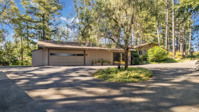 1019 Westside Rd, Healdsburg, CA 95448 - view of front of property with asphalt driveway, a garage, and board and batten siding