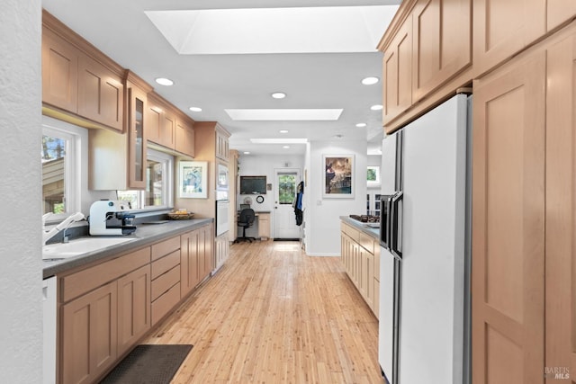 1019 Westside Rd, Healdsburg, CA 95448 - kitchen featuring white fridge with ice dispenser, a skylight, light wood finished floors, a sink, and recessed lighting