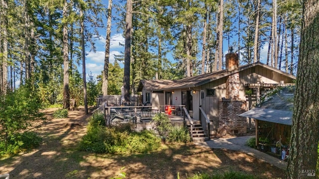 1019 Westside Rd, Healdsburg, CA 95448 - rear view of property with a chimney, a deck, board and batten siding, and brick siding