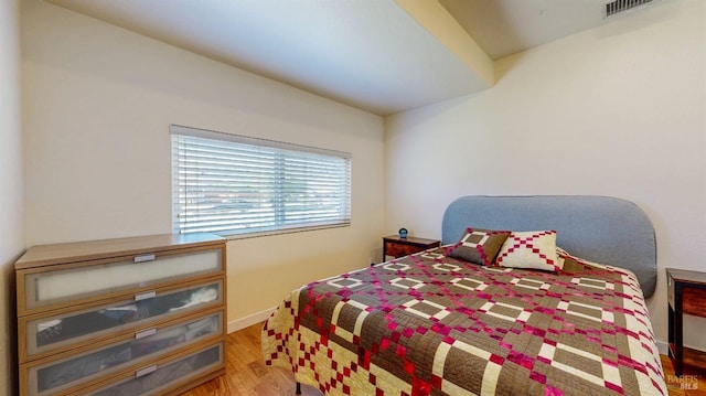 bedroom featuring wood finished floors and baseboards