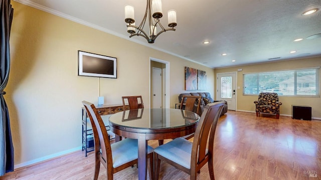 dining room featuring a chandelier, baseboards, light wood-type flooring, crown molding, and recessed lighting