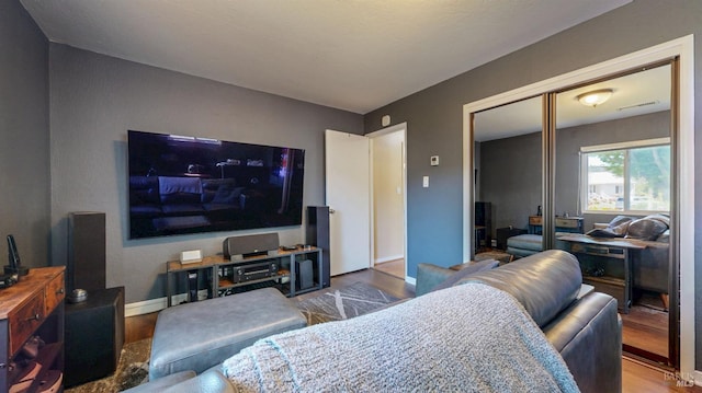 living area with wood finished floors and baseboards