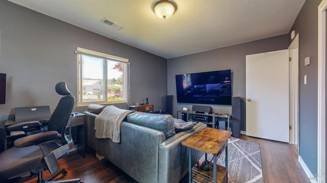 living area featuring dark wood-type flooring and a desk