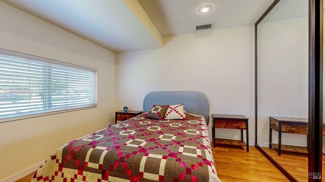 bedroom with wood finished floors and baseboards