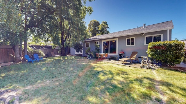 rear view of property with stucco siding and a patio