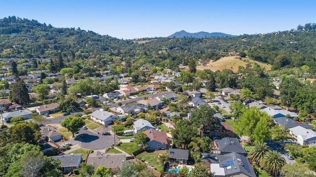 aerial overview of property's location featuring a mountain backdrop and nearby suburban area