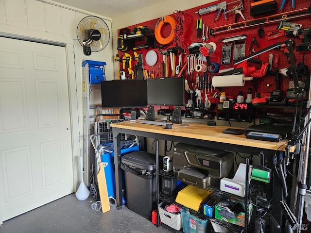 office with a workshop area and finished concrete floors
