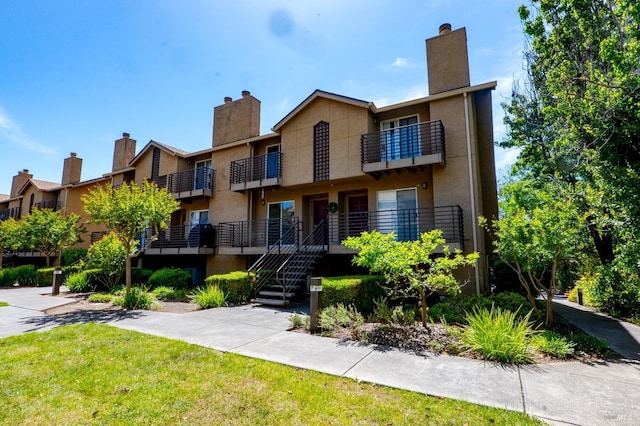 1132 Pear Tree Ln, Napa, CA 94558 - view of property with a chimney, a balcony, and stairway
