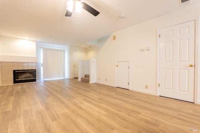 1132 Pear Tree Ln, Napa, CA 94558 - unfurnished living room with a ceiling fan, a tile fireplace, light wood-type flooring, stairway, and baseboards