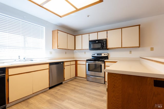 1132 Pear Tree Ln, Napa, CA 94558 - kitchen featuring appliances with stainless steel finishes, a sink, light wood-type flooring, and light countertops