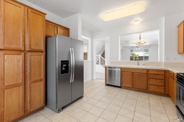 1049 Villaggio Cir, Vacaville, CA 95688 - kitchen with stainless steel appliances, brown cabinetry, light tile patterned floors, and a sink