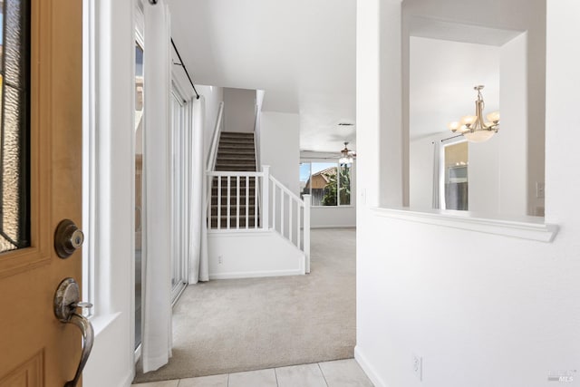 1049 Villaggio Cir, Vacaville, CA 95688 - tiled foyer featuring carpet flooring, stairway, a chandelier, ceiling fan, and baseboards