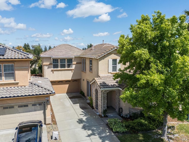 1049 Villaggio Cir, Vacaville, CA 95688 - view of front of property featuring a garage, driveway, stucco siding, and a tiled roof