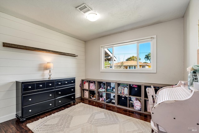 1805 Central Ave, Napa, CA 94558 - bedroom featuring dark wood-type flooring, wood walls, baseboards, and a textured ceiling