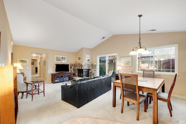 226 Usher Dr, Windsor, CA 95492 - dining room featuring light carpet, vaulted ceiling, plenty of natural light, and a stone fireplace