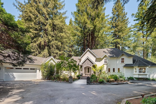 711 Furlong Rd, Sebastopol, CA 95472 - view of front of house with stucco siding, a garage, driveway, and stone siding