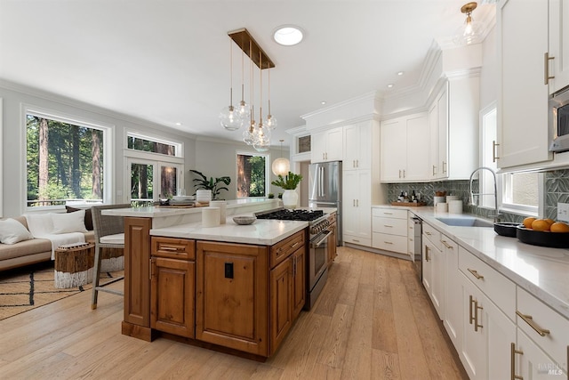 711 Furlong Rd, Sebastopol, CA 95472 - kitchen featuring stainless steel appliances, a sink, crown molding, brown cabinets, and white cabinets