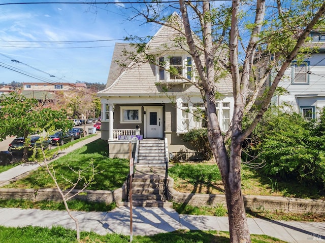 view of front of property with a porch and stairs