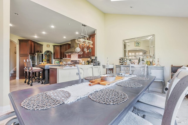 dining area with recessed lighting, arched walkways, baseboards, and a chandelier