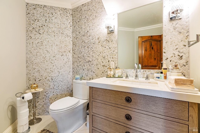 bathroom featuring crown molding, toilet, vanity, and tile patterned floors