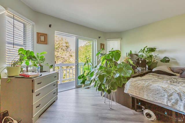 bedroom with access to outside and light wood finished floors