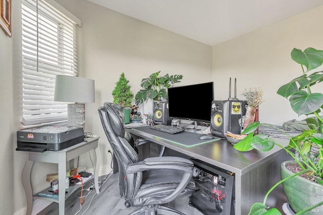 home office with baseboards and wood finished floors