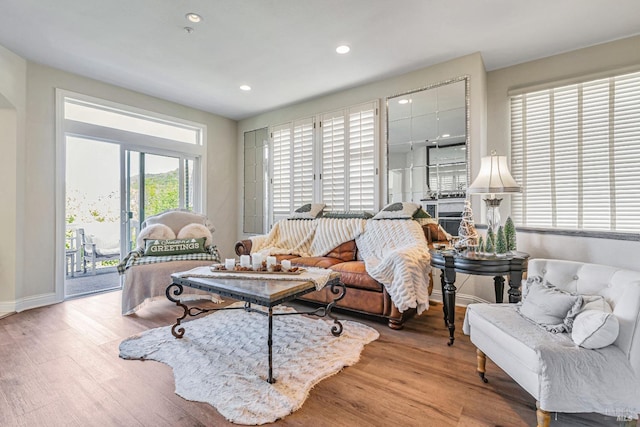 living room with wood finished floors, recessed lighting, and baseboards