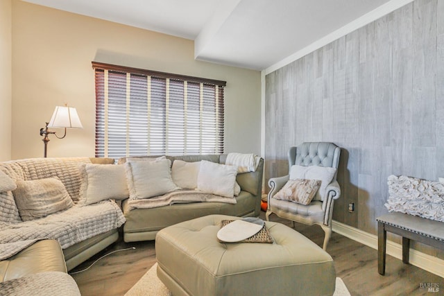 living area with wood finished floors and baseboards