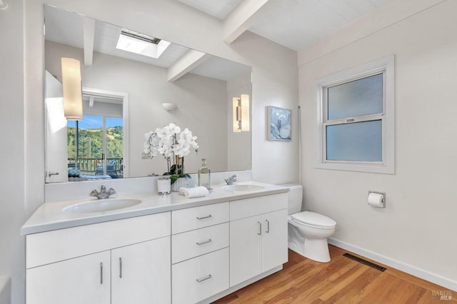 4444 Redwood Rd, Napa, CA 94558 - bathroom with beamed ceiling, toilet, double vanity, wood finished floors, and baseboards