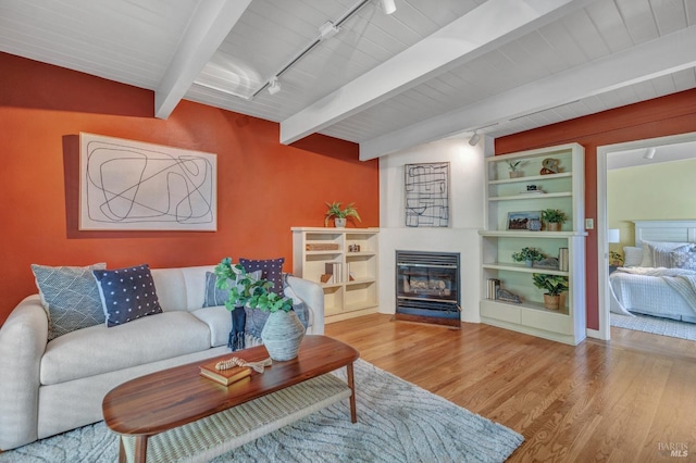 4444 Redwood Rd, Napa, CA 94558 - living area with track lighting, beam ceiling, wood finished floors, and a fireplace with flush hearth