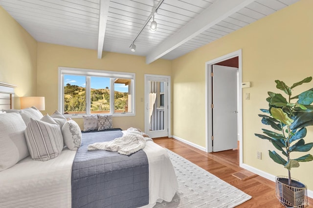 4444 Redwood Rd, Napa, CA 94558 - bedroom with baseboards, wood finished floors, track lighting, beam ceiling, and access to exterior