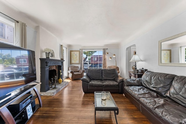 32 Muller St, Vallejo, CA 94590 - living room with a fireplace with raised hearth, wood finished floors, and arched walkways
