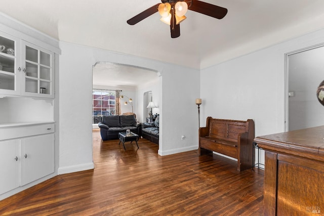 32 Muller St, Vallejo, CA 94590 - sitting room featuring a ceiling fan, arched walkways, dark wood-style flooring, and baseboards