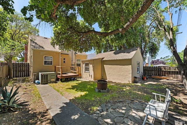 32 Muller St, Vallejo, CA 94590 - rear view of house with stucco siding, a wooden deck, a fenced backyard, and a shingled roof