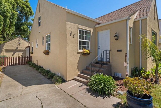32 Muller St, Vallejo, CA 94590 - view of front facade with stucco siding, fence, and roof with shingles