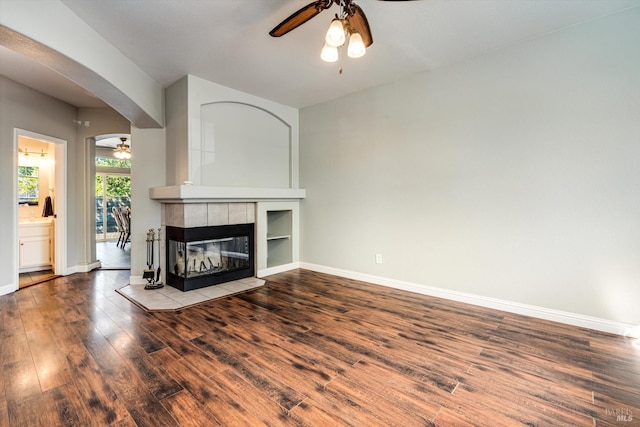 9227 Berwyn Way, Windsor, CA 95492 - unfurnished living room with a ceiling fan, wood finished floors, arched walkways, and baseboards