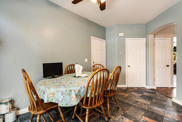 9227 Berwyn Way, Windsor, CA 95492 - dining area featuring arched walkways, ceiling fan, baseboards, and stone finish floors