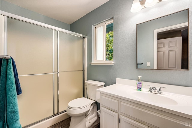 9227 Berwyn Way, Windsor, CA 95492 - full bathroom with a textured wall, a shower stall, toilet, vanity, and wood finished floors