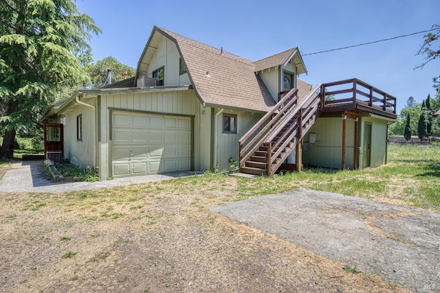 17651 Van Arsdale Rd, Potter Valley, CA 95469 - rear view of property featuring a garage, stairs, a shingled roof, driveway, and a gambrel roof