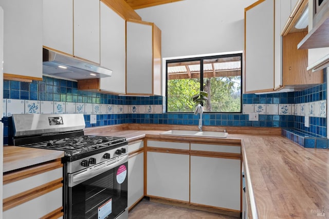 17651 Van Arsdale Rd, Potter Valley, CA 95469 - kitchen featuring gas stove, under cabinet range hood, a sink, white cabinetry, and backsplash
