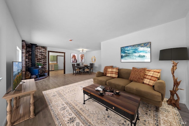 17651 Van Arsdale Rd, Potter Valley, CA 95469 - living area featuring a wood stove, wood finished floors, and baseboards