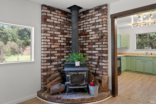 17651 Van Arsdale Rd, Potter Valley, CA 95469 - detailed view of a wood stove, a sink, and wood finished floors