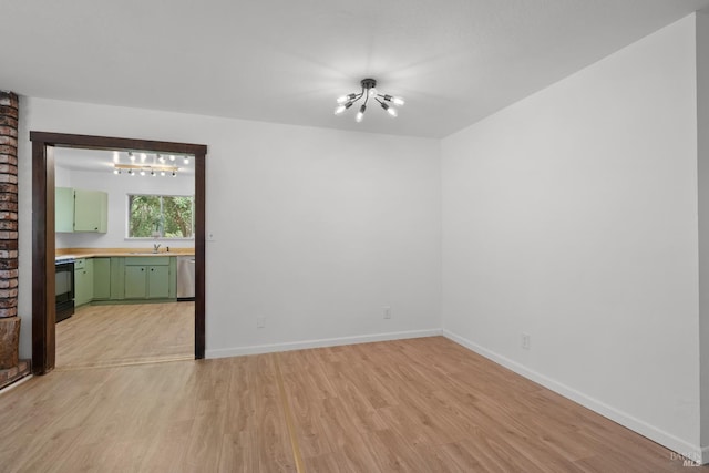 17651 Van Arsdale Rd, Potter Valley, CA 95469 - empty room featuring a chandelier, light wood finished floors, baseboards, and a sink