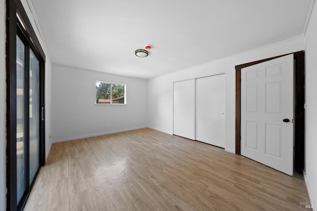 17651 Van Arsdale Rd, Potter Valley, CA 95469 - unfurnished bedroom with light wood-type flooring, a closet, baseboards, and ornamental molding