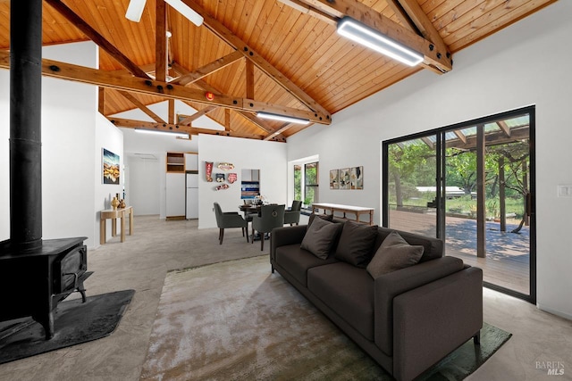 17651 Van Arsdale Rd, Potter Valley, CA 95469 - living room featuring high vaulted ceiling, wooden ceiling, beam ceiling, a wood stove, and a ceiling fan